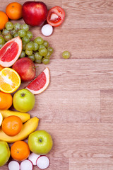 Fruits and vegetables on a wooden background