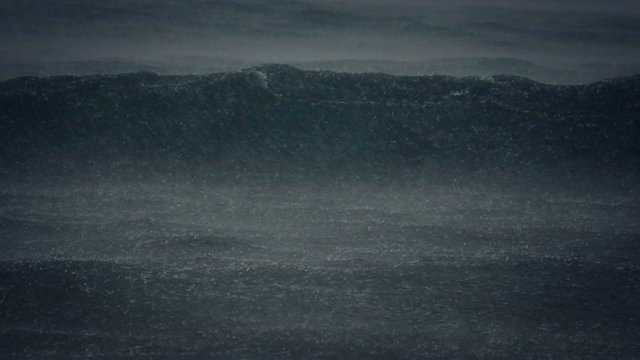 slow motion view of heavy rain dropping on the ocean waves
