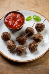 Close-up of meatballs with a dip sauce, selective focus