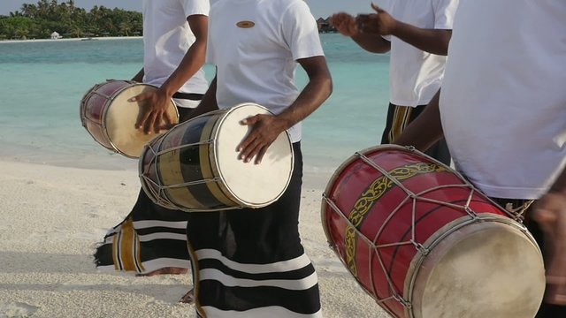 Local People Playing Drums On The Sandy Maldives Beach
