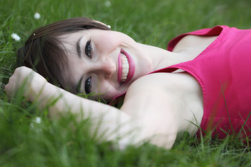 Smiling woman relaxing on the lawn