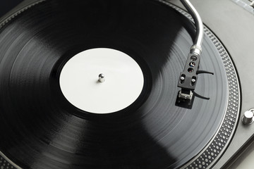 Turntable playing vinyl close up with needle on the record