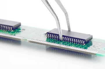 Tweezers Holding Little Circuit Board Part Isolated On White