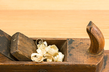 Old wooden plane on wooden background