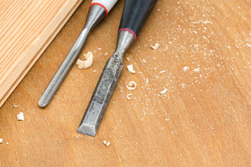 Chisels on wooden background