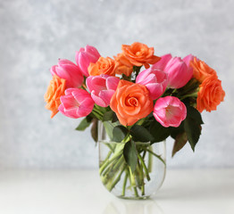 Roses and tulips in a glas vase