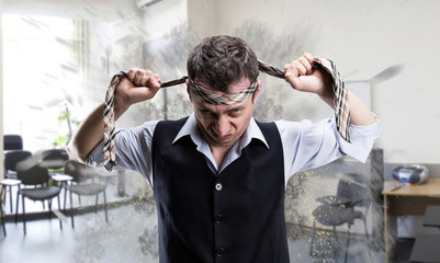 Agressive businessman with a tie on his head