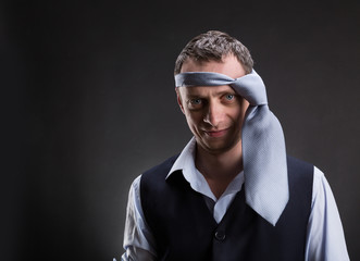 Funny man with necktie on his head