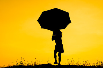 Umbrella girl with sunset silhouette