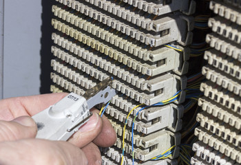 Close of hands punching down circuit panel 2