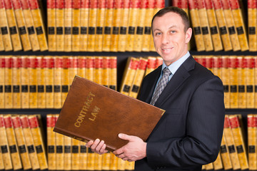 Young Lawyer with law books in the background - 81390634
