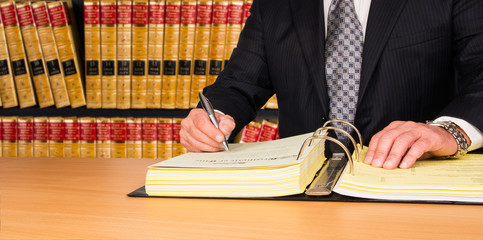 Lawyer signing legal documents - 81390651