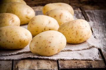 Fototapeta na wymiar Fresh organic raw potatoes on sacking