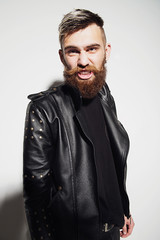 Emotional portrait of a bearded man in a leather jacket