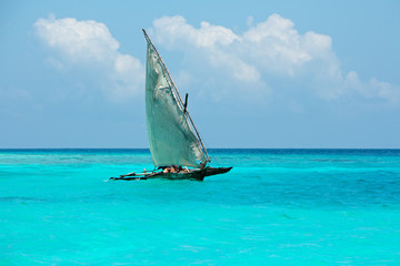 Wooden sailboat (dhow) on water, Zanzibar - obrazy, fototapety, plakaty