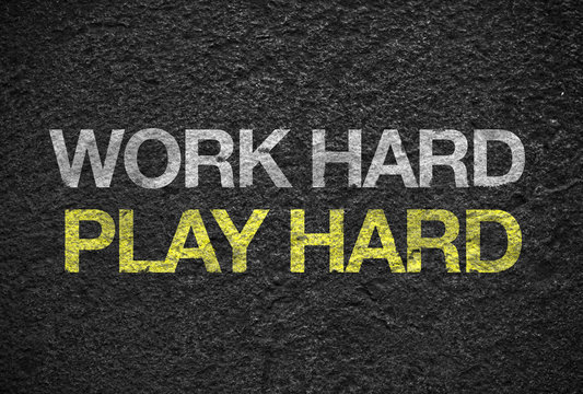 Inspiration quote : " Work hard play hard " on black rough stone