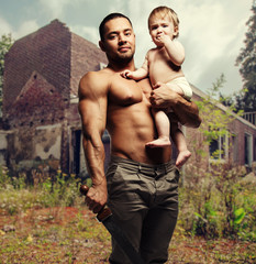 Father hugging a baby and holding a sword