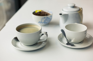 Teapot and cups on table