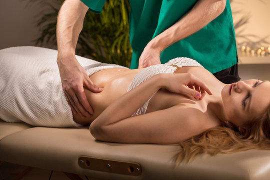 Woman having done abdominal massage