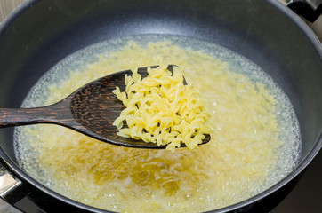 Boil macaroni in a pot