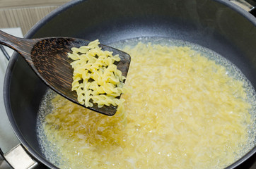 Boil macaroni in a pot