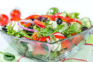 Salad with fresh vegetables in a glass bowl