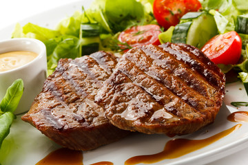 Grilled steaks and vegetable salad