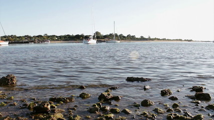 Boat traveling in background at Tavira Island