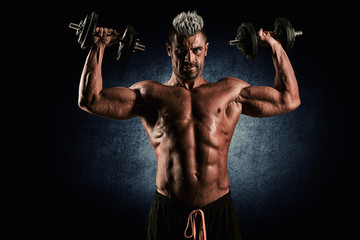 Strong bodybuilder man with perfect abs, shoulders,biceps, trice