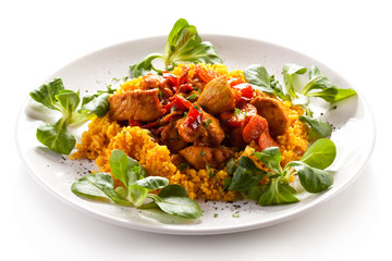 Roasted meat with pearl barley and vegetables on white backgroun