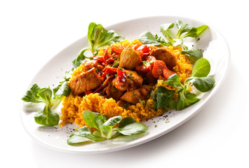 Roasted meat with pearl barley and vegetables on white backgroun