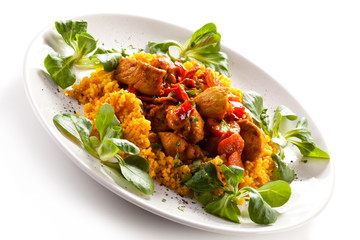 Roasted meat with pearl barley and vegetables on white backgroun