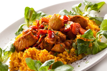 Roasted meat with pearl barley and vegetables on white backgroun