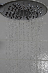 Naklejka na ściany i meble Shower head with water drops freeze motion