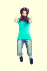 Casual woman jumping showing OK.