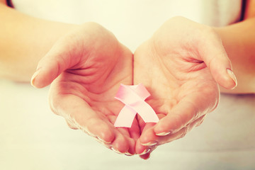 Hands holding pink breast cancer awareness ribbon