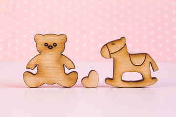 Wooden icons of Teddy bear and children's rocking horse with lit