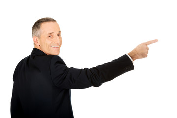 Back view businessman pointing right