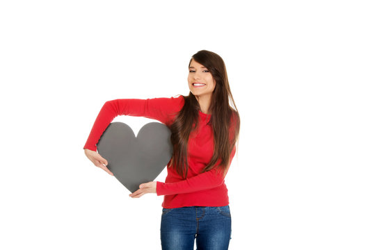 Young woman with heart made from paper.