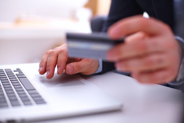 Fototapeta premium Businessman using his credit card for an online transaction