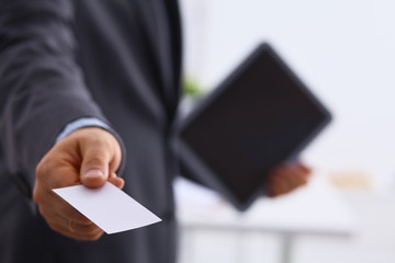 Man's hand showing business card
