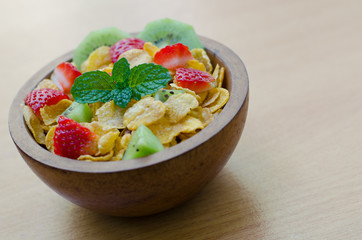 Cereals with fruit in wooden bowl