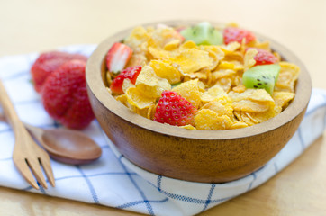 Cereals with fruit in wooden bowl