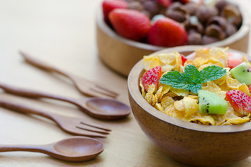 Cereals with fruit in wooden bowl