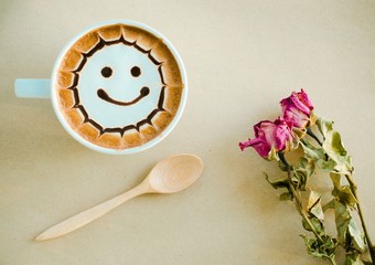 a cup of latte art on brown paper background