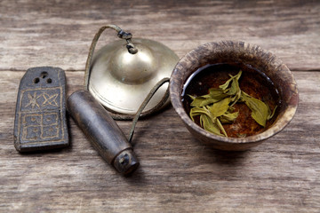 Buddhist supplies with cup of zen tea