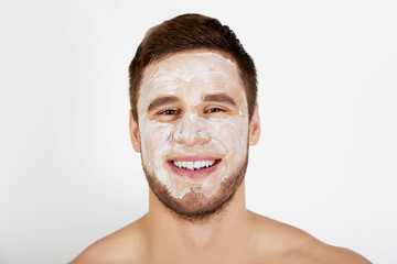 Obraz premium Man with cream moisturizer on his face.
