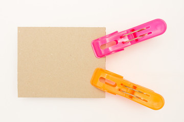 Cardboard with Pink and Orange Clothes Pins