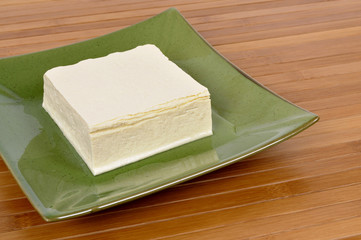 Block of fresh Tofu on a serving plate photo
