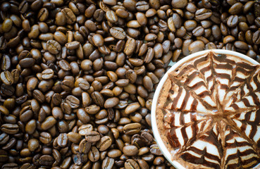 a cup of latte art on coffee bean background